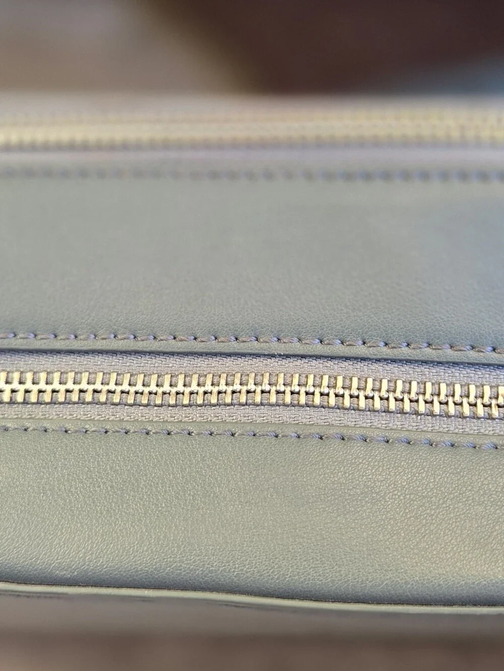 This is a TWELVElittle x The Sensible Mama Clutch in a muted blue vegan leather.